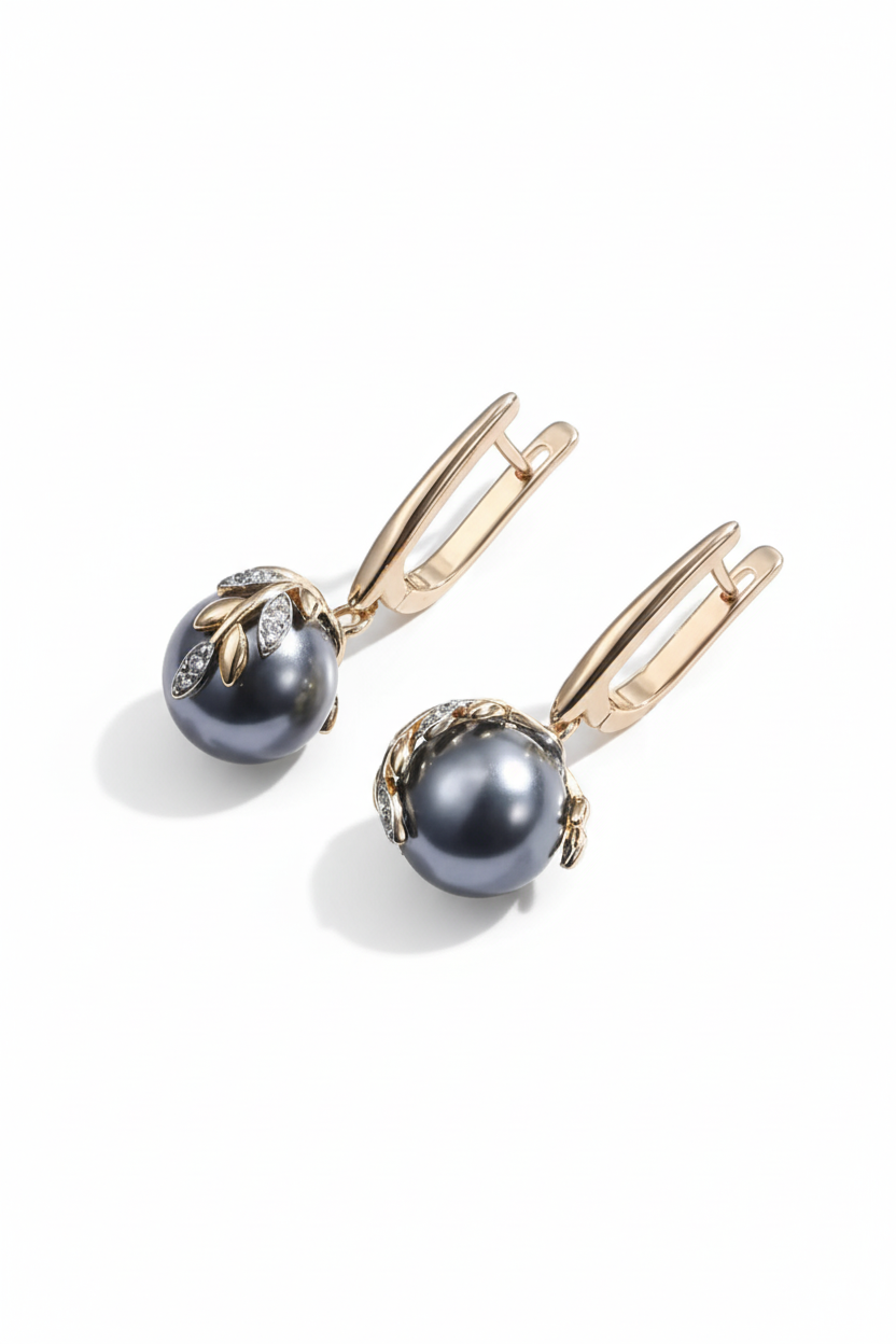 Elegant long drop earrings featuring a deep black pearl accent and a textured 18K gold-plated S925 silver knot detail by Nura Label.