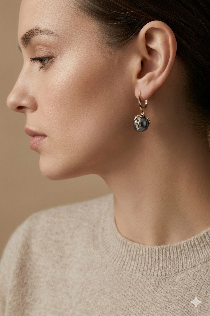 Elegant long drop earrings featuring a deep black pearl accent and a textured 18K gold-plated S925 silver knot detail by Nura Label.