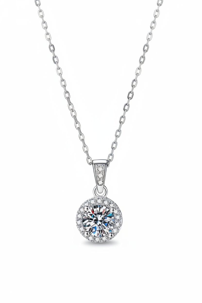 Close-up of The Lyra pendant, featuring a brilliant 1.0 carat round-cut moissanite inside a classic round pavé halo in solid 925 silver.