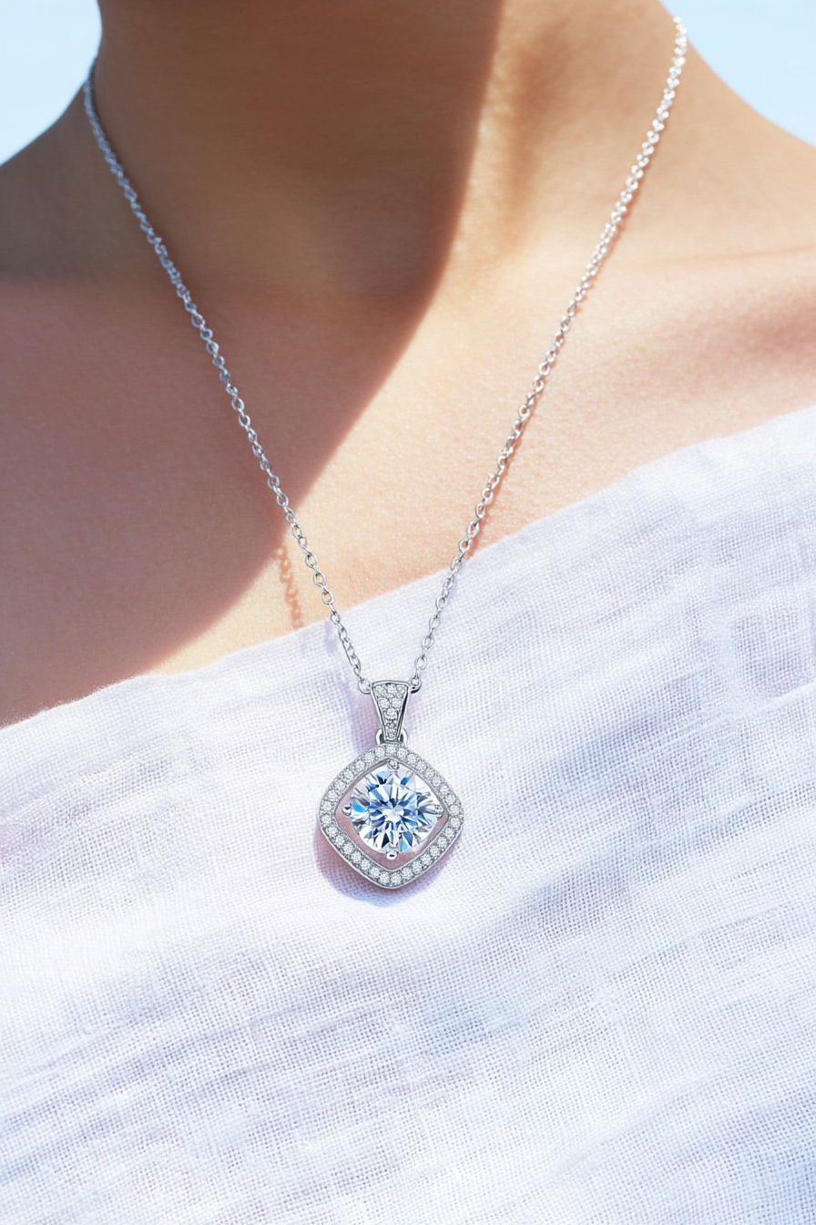 Close-up of The Aurelia pendant featuring a 1.0 carat moissanite surrounded by a cushion-shaped pavé halo in solid 925 sterling silver.