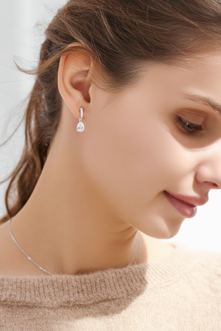 Close-up of The Lyra drop earrings featuring a brilliant clear teardrop-shaped stone in a high-polish solid 925 sterling silver setting.