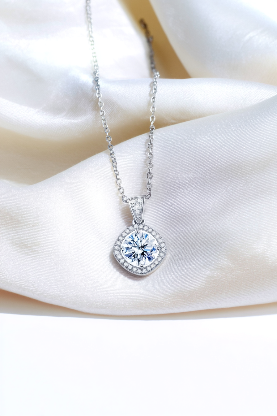 Close-up of The Aurelia pendant featuring a 1.0 carat moissanite surrounded by a cushion-shaped pavé halo in solid 925 sterling silver.