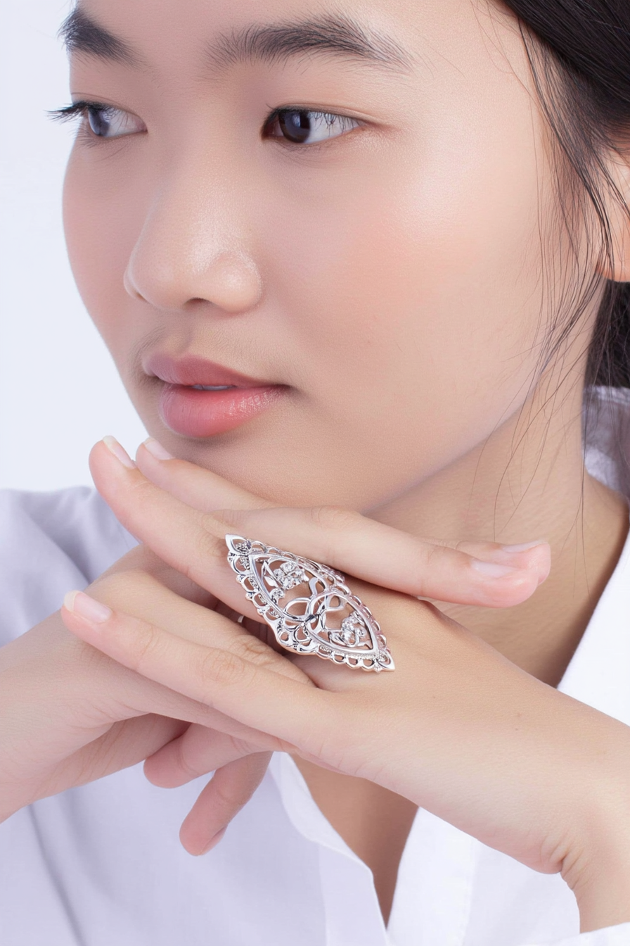 Intricate 925 sterling silver filigree shield ring featuring a hollow-out floral lace pattern, handcrafted statement jewelry by Nura Label.