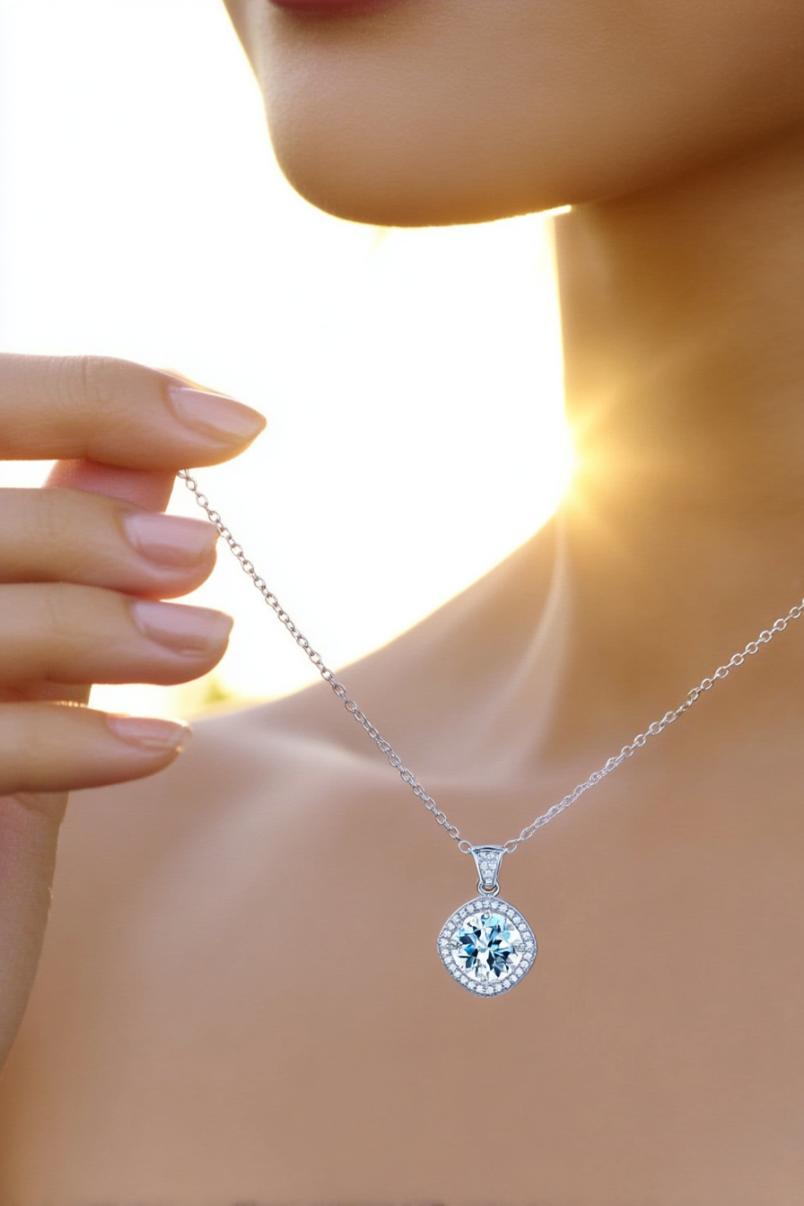 Close-up of The Aurelia pendant featuring a 1.0 carat moissanite surrounded by a cushion-shaped pavé halo in solid 925 sterling silver.