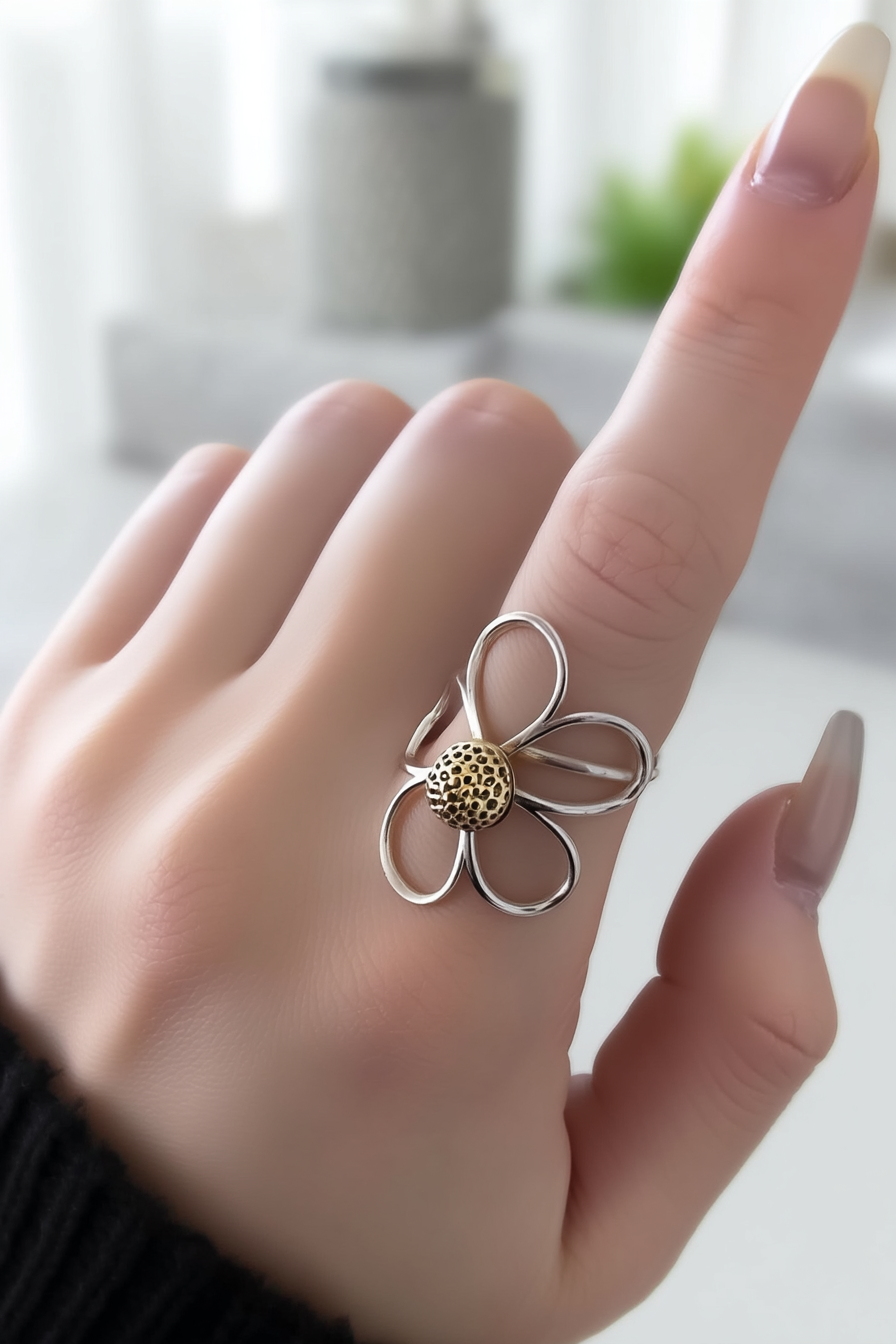 Delicate 925 sterling silver ring with a hollow-out clover floral design, minimalist handcrafted silver jewelry by Nura Label.