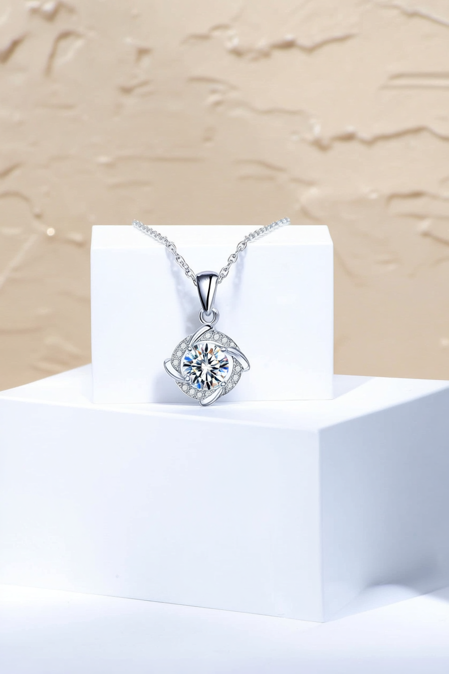 Close-up of The Nova pendant, featuring a 1.0 carat round moissanite stone centered inside a sharp square pavé halo in solid 925 silver.