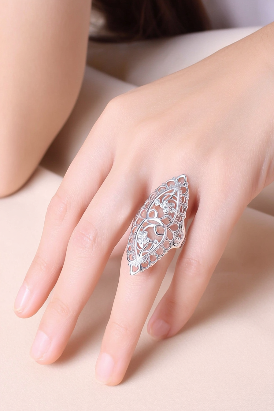 Intricate 925 sterling silver filigree shield ring featuring a hollow-out floral lace pattern, handcrafted statement jewelry by Nura Label.