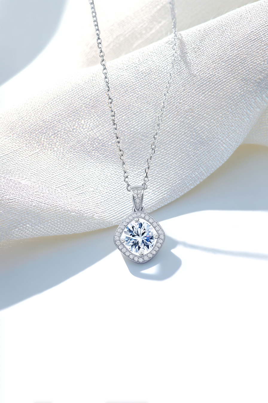 Close-up of The Aurelia pendant featuring a 1.0 carat moissanite surrounded by a cushion-shaped pavé halo in solid 925 sterling silver.