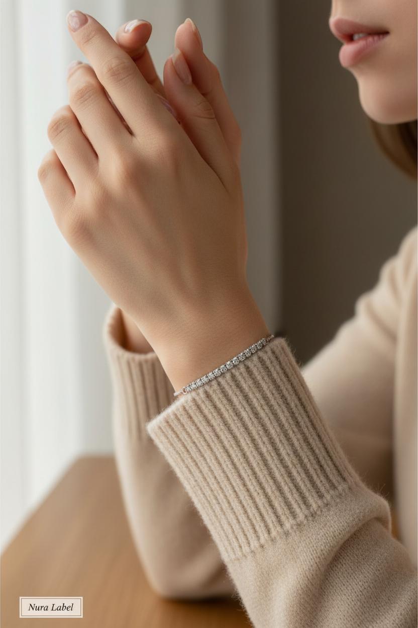 Minimalist 925 sterling silver Vera tennis bracelet on a woman's wrist.
