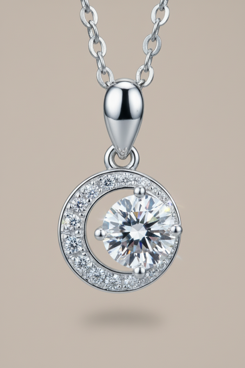 Close-up of The Selene Necklace featuring a 1.0 carat moissanite center stone cradled by a pavé crescent moon, set in solid 925 sterling silver.