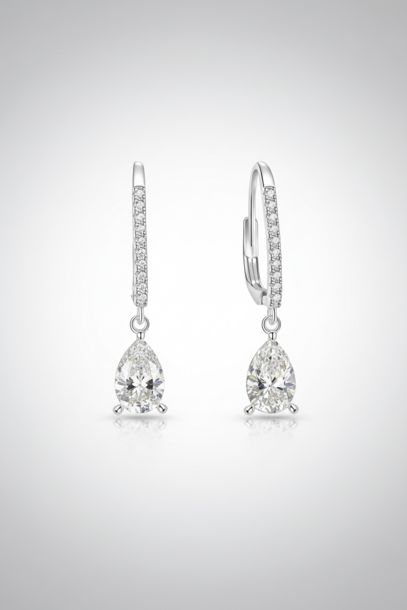 Close-up of The Lyra drop earrings featuring a brilliant clear teardrop-shaped stone in a high-polish solid 925 sterling silver setting.