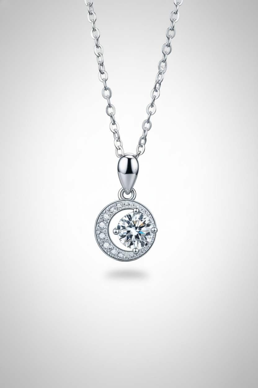 Close-up of The Selene Necklace featuring a 1.0 carat moissanite center stone cradled by a pavé crescent moon, set in solid 925 sterling silver.