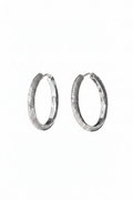 Close-up of The Étoile textured hoops, showcasing the sparkling frosted stardust finish on solid 925 sterling silver circles.