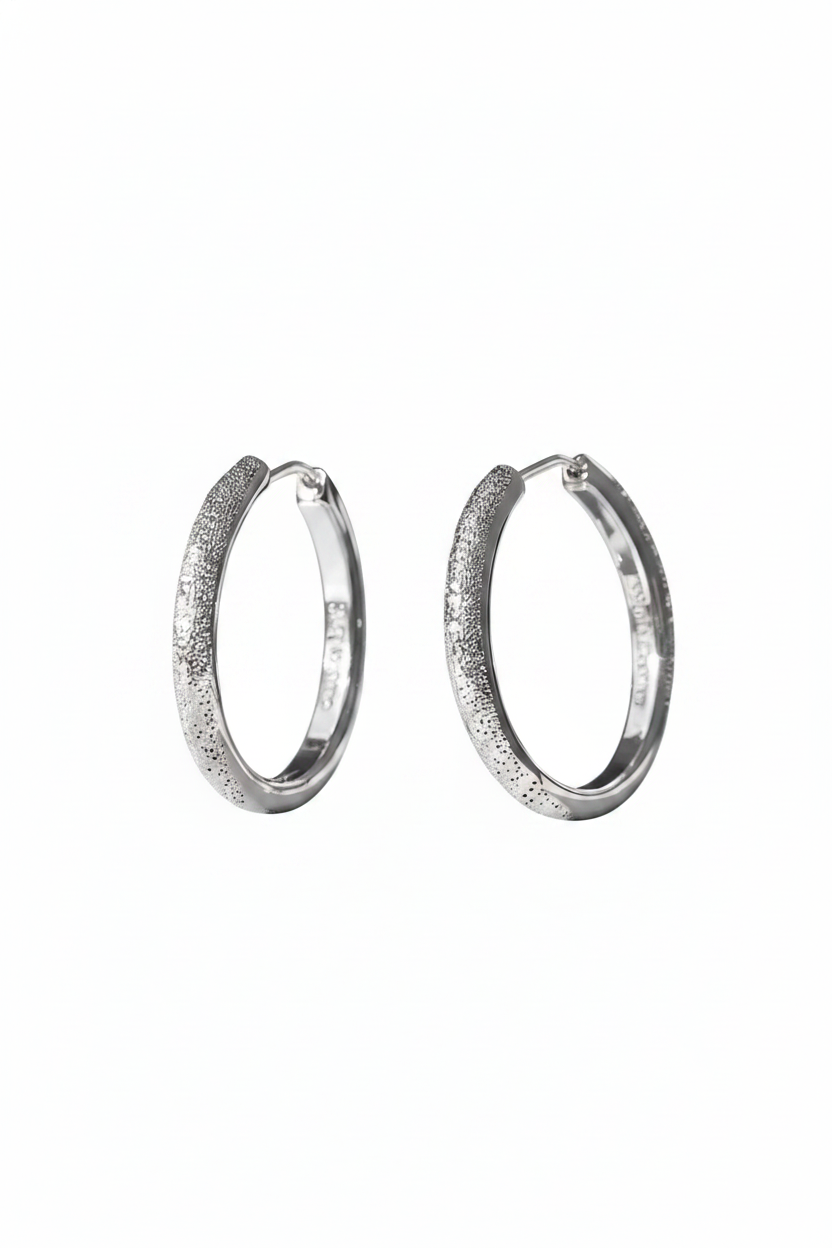 Close-up of The Étoile textured hoops, showcasing the sparkling frosted stardust finish on solid 925 sterling silver circles.